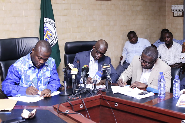 Mr Mohammed Adjei Sowah (left) with Mr Kwabena Asiedu Gyang (middle) and Mr Benjamin Arthur during the signing of the MoU